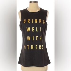 size medium grey halter top that says in gold letters “ drinks well with others”